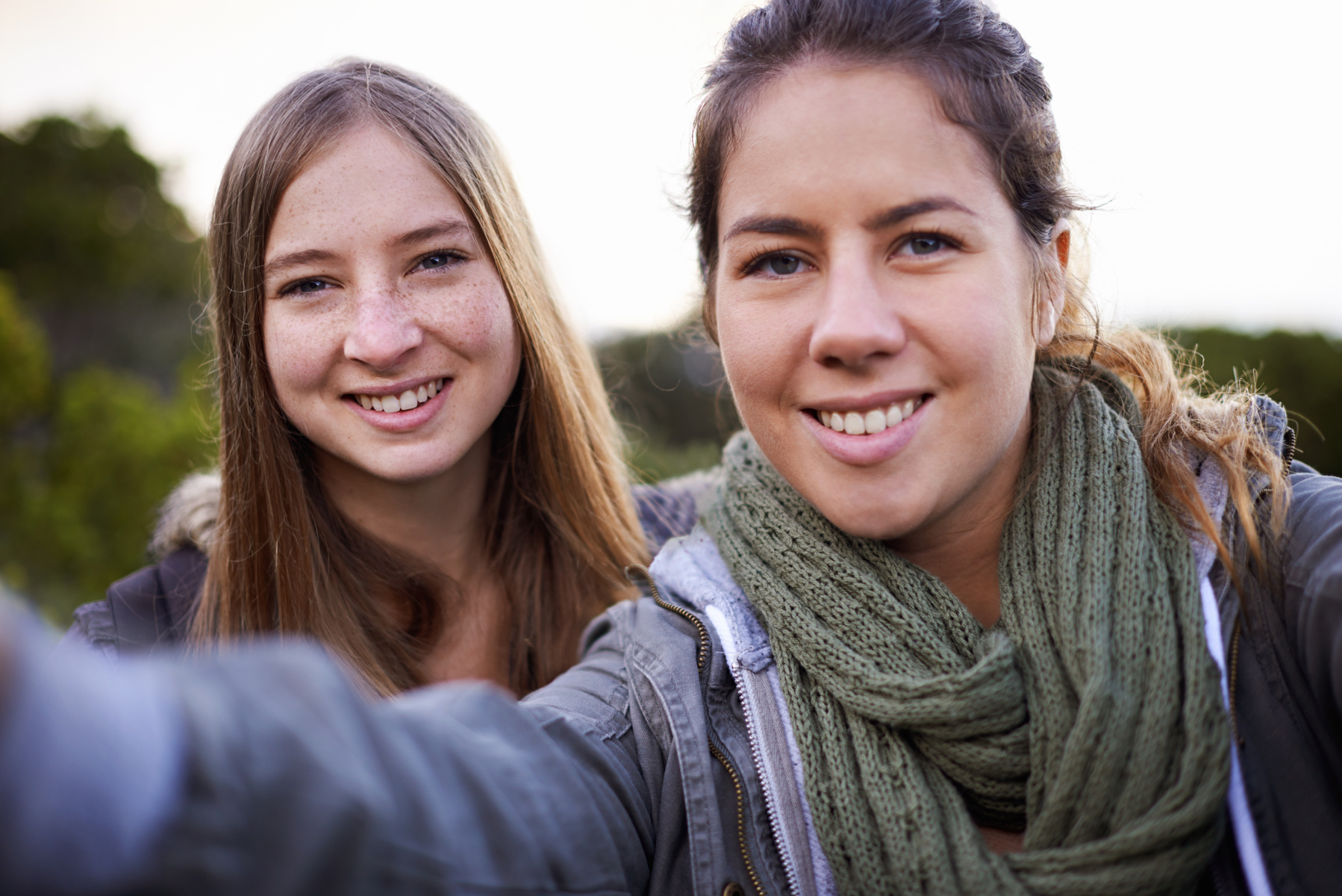 Selfie av två unga kvinnliga kompisar i ett landskap i norra Sverige.